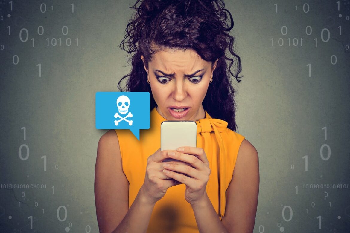 anxious_woman_looks_at_her_mobile_phone_smishing_by_siphotography_gettyimages-668299932_binary_by_tonivaver_via_gettyimages-827840478_skull_by_jane_kelly_gettyimages-669307004_2400x1600-100839560-large.jpg